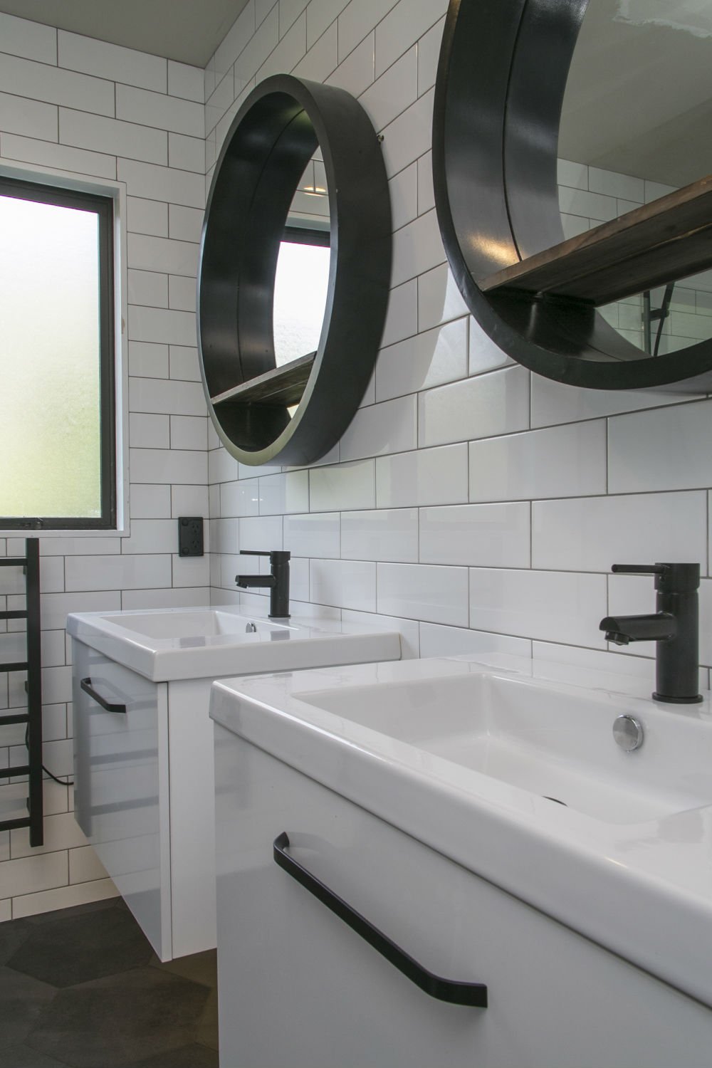 Two white floating vanities with matte black tapware in Epsom