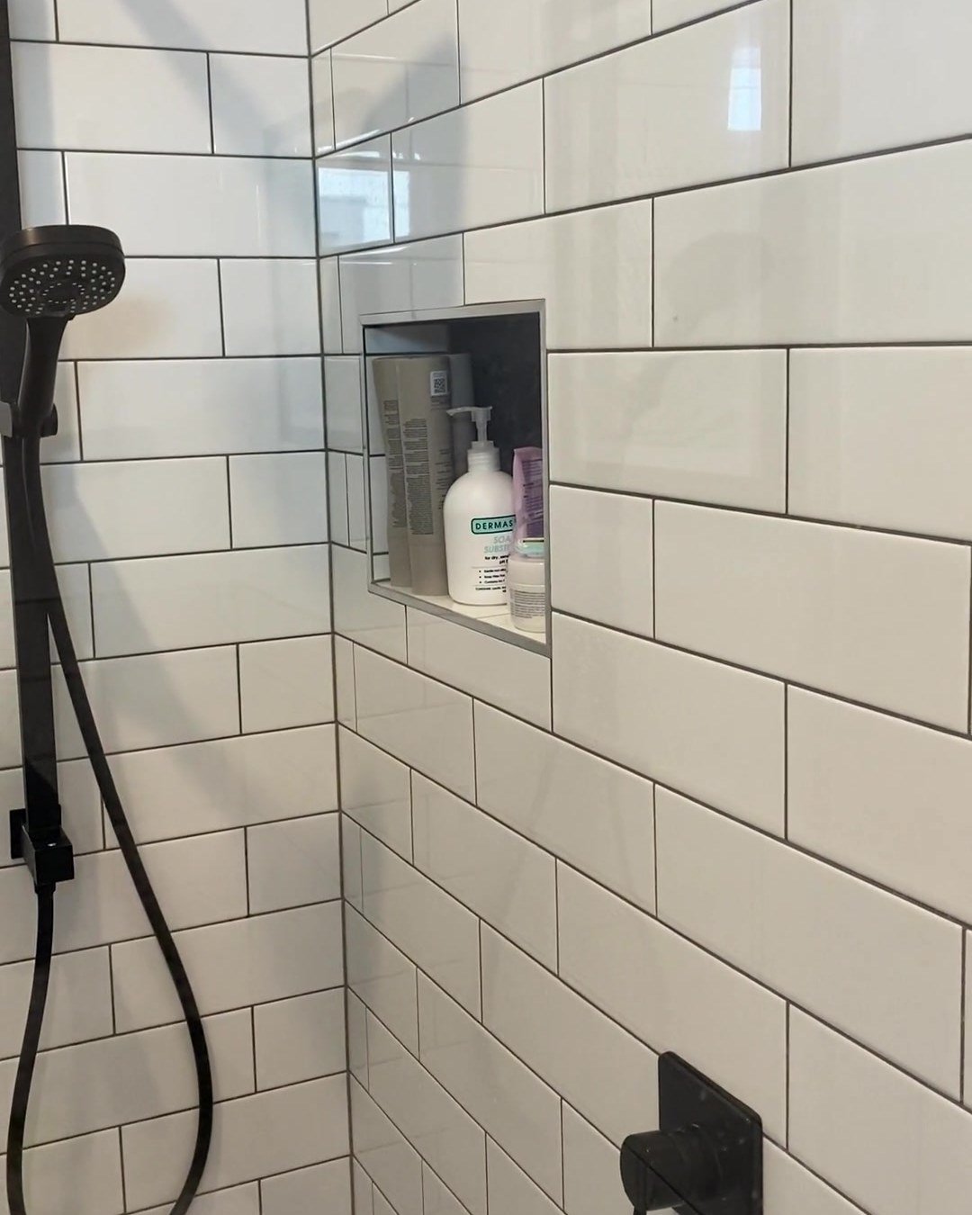 Black rail shower and a recessed shower niche in white subway tiles, Albany bathroom