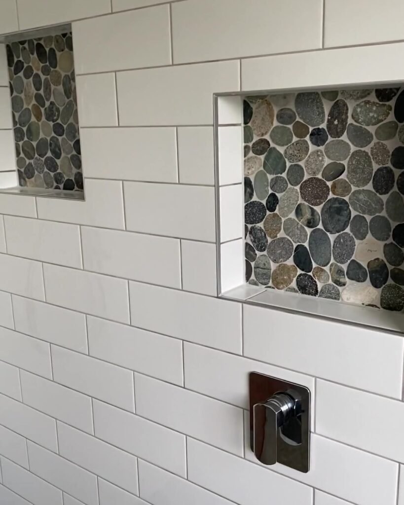 cockle-bay-shower-niche-mixer Pebble-backed shower niche above a chrome mixer in a Cockle Bay walk-in shower