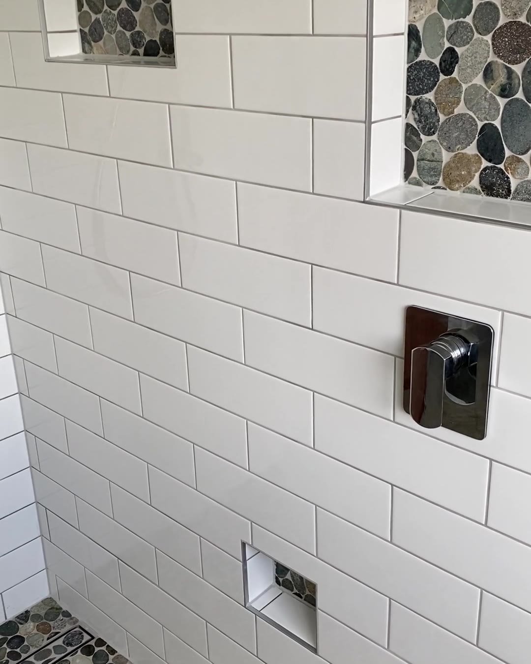 cockle-bay-shower-niches-pebble Two river-pebble shower niches and a low recess in white subway tiles, Cockle Bay bathroom