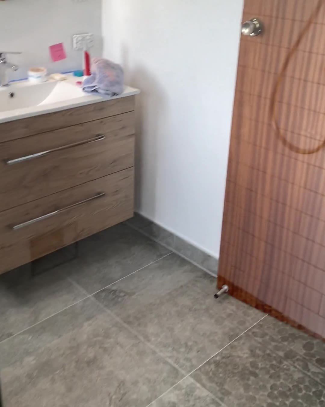 Wall-hung oak-look vanity with two drawers in a renovated Cockle Bay bathroom