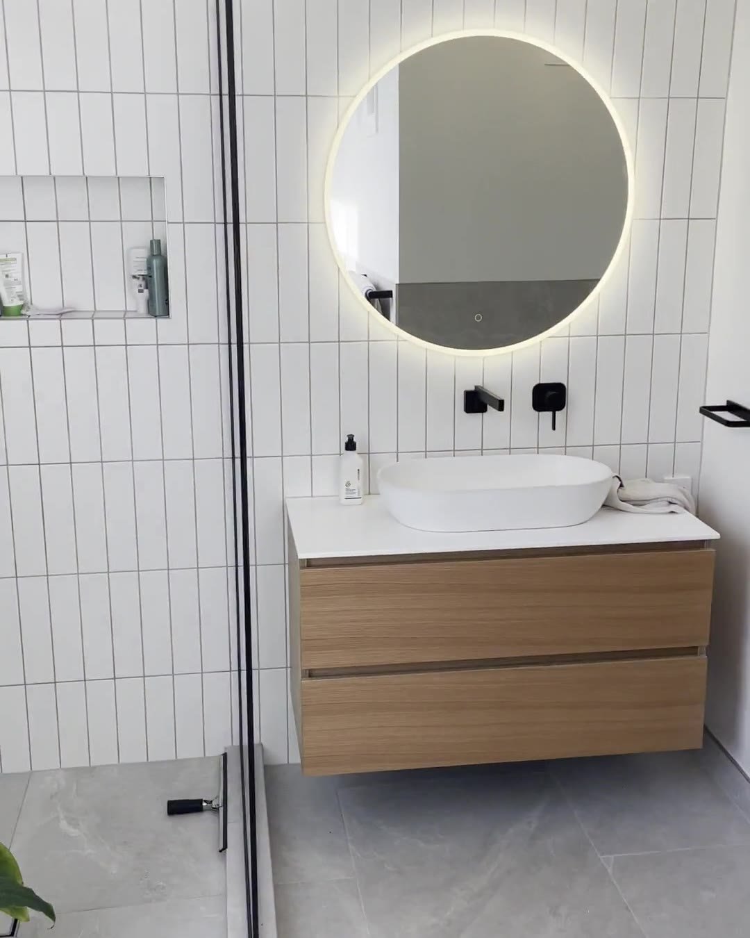 mount-eden-bathroom-vanity-mirror Wall-hung oak-look vanity with a vessel basin and a round backlit mirror, Mount Eden bathroom renovation
