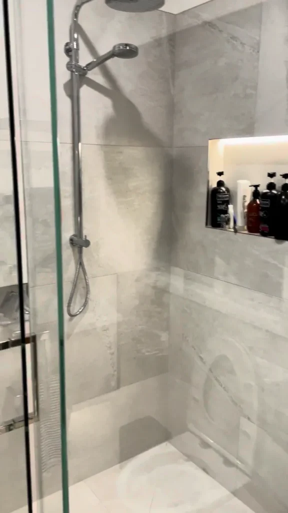 Glendowie Walk In Shower Lit Niche Walk-in shower with a rail shower, rain head and lit niche in large marble-look tiles, Glendowie