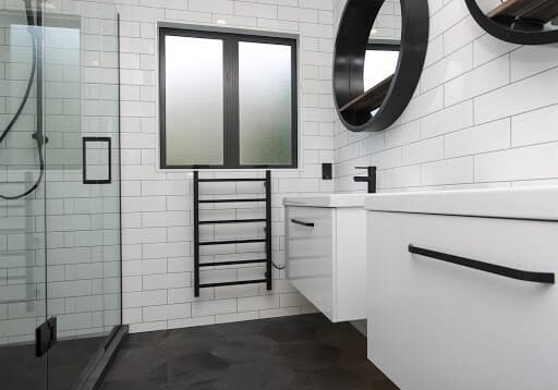 alchemy bathroom auckland Glass shower, black towel rail and white subway tiles in an Epsom bathroom