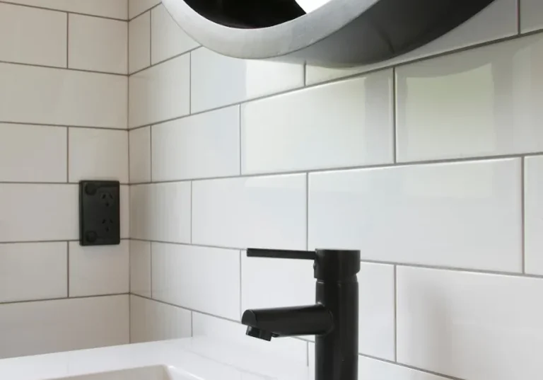 bathroom alchemy Matte black basin mixer against white subway tiles in an Epsom bathroom