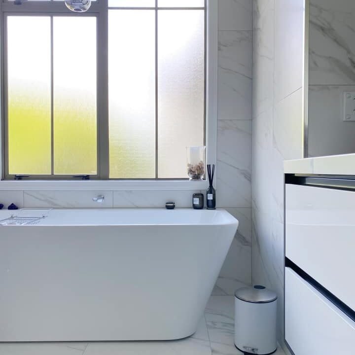 bathroom remodeling auckland Freestanding bath under a window in a renovated St Heliers bathroom