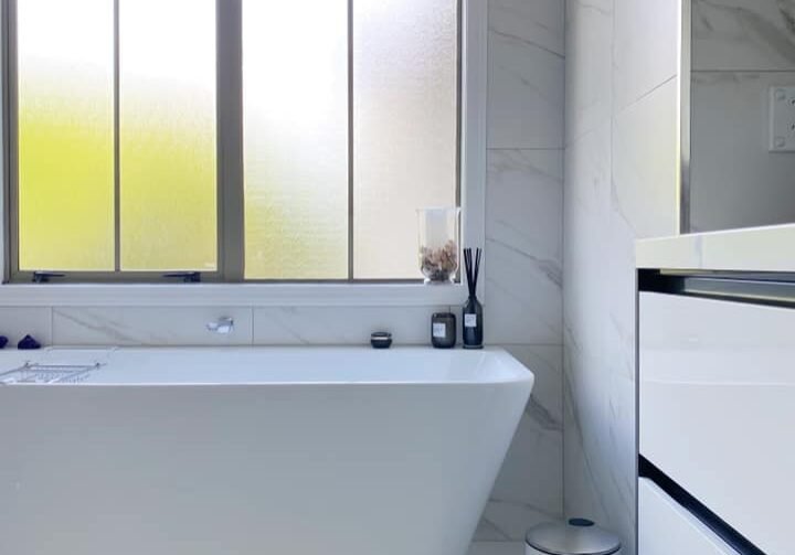 bathroom remodeling auckland Freestanding bath under a window in a renovated St Heliers bathroom