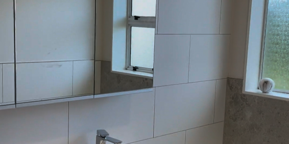 bathroom renovation botany Wide vanity with drawers and mirrored cabinet in a renovated Botany bathroom