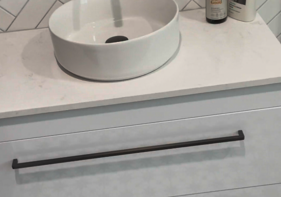 bathroom renovations st johns Drawer vanity with a round vessel basin and herringbone tiles in a St Johns bathroom
