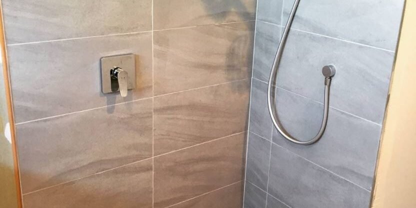 Walk-in shower with linear drain and niche in a Bayview ensuite