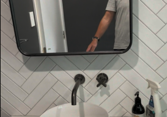 bathroom renovators st johns Herringbone wall tiles, framed mirror and vessel basin in a St Johns bathroom