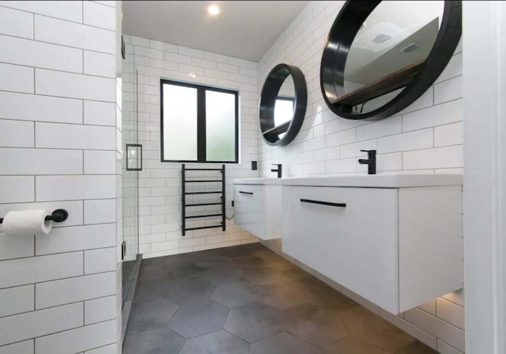 bathrooms auckland Twin wall-hung vanities and round mirrors in an Epsom bathroom renovation
