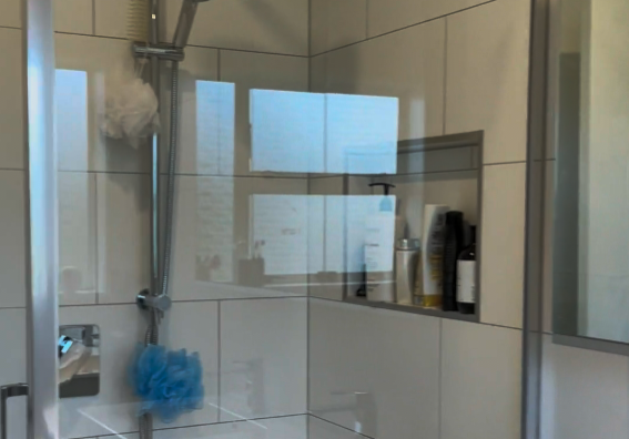 Glass shower with rail shower and recessed niche in a Botany bathroom renovation