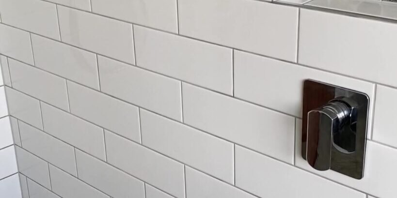 cockle-bay-shower-niches-pebble Two river-pebble shower niches and a low recess in white subway tiles, Cockle Bay bathroom