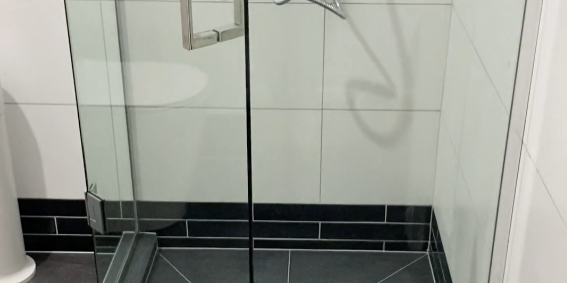 custom tiled shower in ponsonby Custom tiled shower with a black tiled base and frameless glass in a Ponsonby bathroom