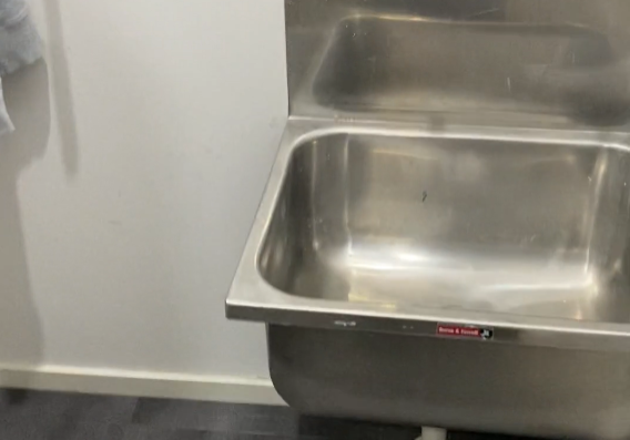 laundy room renovations Stainless steel laundry tub with wall-mounted taps in a Ponsonby laundry renovation