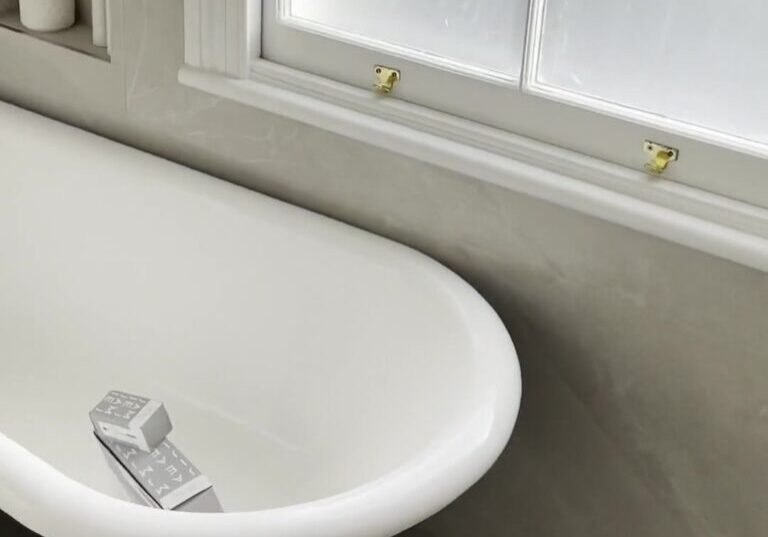 mount-eden-bathroom-clawfoot-bath-window White clawfoot bath with black feet under a frosted sash window in a Mount Eden bathroom