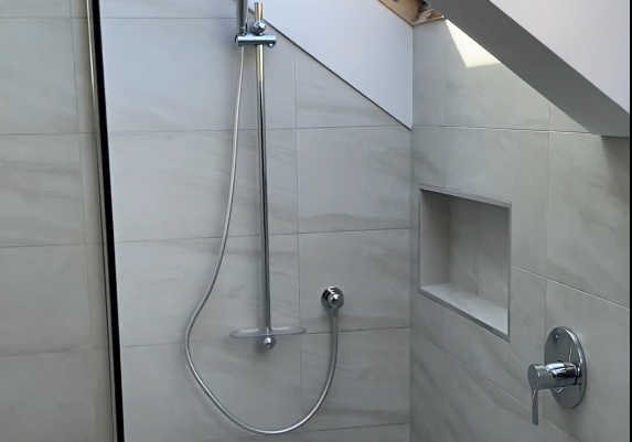 Ensuite shower with recessed niche and rail shower in a Bayview renovation