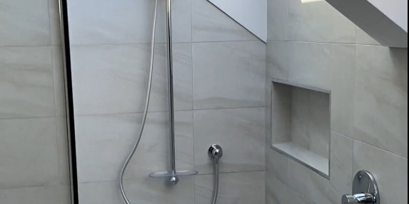 single panel shower Ensuite shower with recessed niche and rail shower in a Bayview renovation